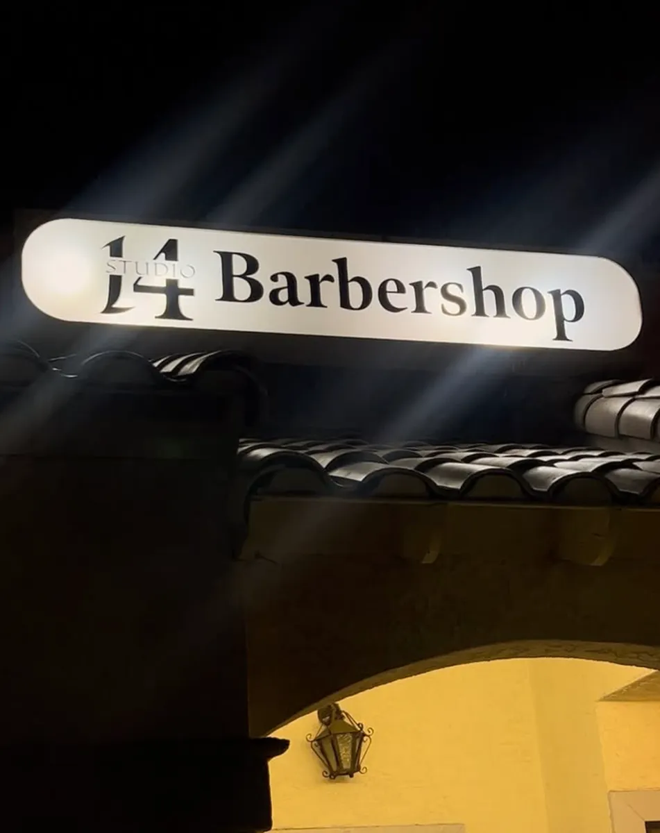 Studio 14 Barbershop sign at night